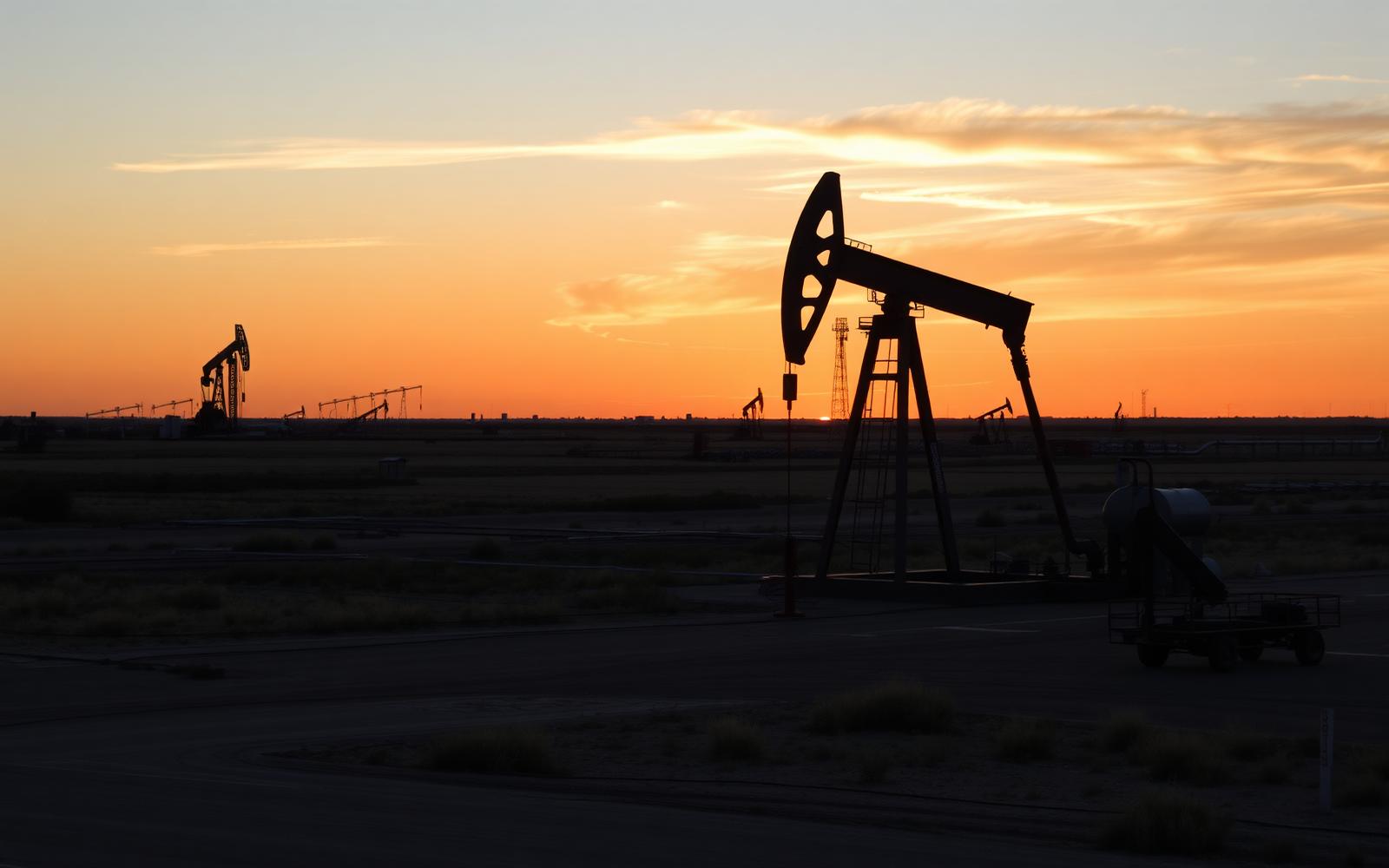 Texas oilfield at golden hour with pumpjacks on the horizon